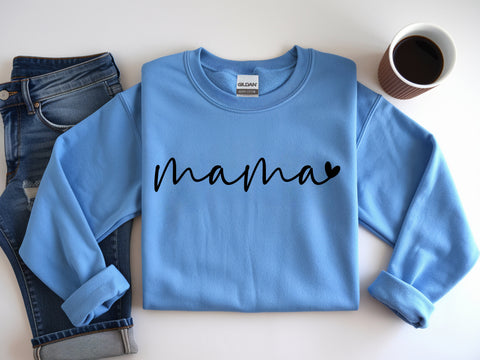 Blue sweatshirt with 'mama' text on a white surface with jeans and coffee.